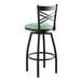A black Lancaster Table & Seating swivel bar stool with a seafoam green cushion.