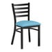 A Lancaster Table & Seating black metal ladder back chair with a blue vinyl padded seat.