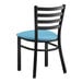 A black Lancaster Table & Seating metal chair with a blue vinyl cushion.