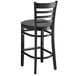 A Lancaster Table & Seating black wood ladder back bar stool with dark gray vinyl seat.