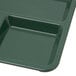 A forest green Carlisle melamine tray with 4 compartments.