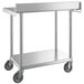 A stainless steel Regency work table with casters.