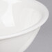 A close up of a CAC Garden State bone white porcelain bowl with a white rim.