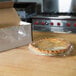 A pie wrapped in Western Plastics perforated film on a counter.