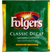 A green and yellow Folgers Classic Decaf package with white text and a logo.