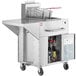 A large stainless steel Backyard Pro fryer with wheels.