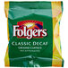A green and yellow Folgers Classic Decaf ground coffee packet with white text.