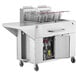 A large stainless steel commercial fryer on wheels with two baskets.