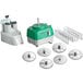 A green and white Avamix Revolution continuous feed food processor with a silver base and various attachments.