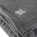 A close-up of a charcoal gray Oxford fleece blanket.