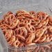 A clear container filled with Tom Sturgis Little Ones pretzels.