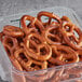 A plastic container filled with Tom Sturgis pretzels.
