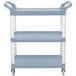 A gray Vollrath utility cart with three shelves and wheels.