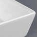A close-up of a CAC China white square bowl.