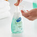 A person using a Dial foaming hand soap pump.