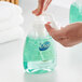 A person using a pump bottle of Dial Professional Basics Hypoallergenic Foaming Hand Wash.