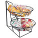 A two tiered metal basket with food in it on a counter.