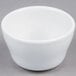 A Tuxton Alaska bright white china bowl on a gray surface.
