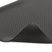 A black rubber Notrax Diamond Sof-Tred anti-fatigue mat with a diamond pattern and curved corner.
