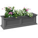 A Mayne Fairfield graphite grey window box with flowers and greenery on a outdoor patio table.