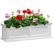 A white rectangular Mayne Fairfield window box with red and pink flowers.