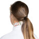 A woman with a ponytail wearing an apple patterned chef neckerchief.