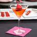 A Libbey Salud Grande Martini Glass filled with a drink and a strawberry on top.