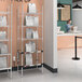 A Metro stainless steel takeout station with heated and chrome shelves and chrome posts.