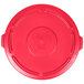 A red plastic lid for a Rubbermaid BRUTE trash can.