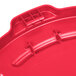 A red Rubbermaid BRUTE trash can lid.