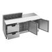 A stainless steel counter top with open drawers on a Beverage-Air sandwich prep table.