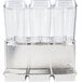 A Crathco stainless steel refrigerated beverage dispenser with three clear plastic containers with lids.