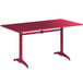 A red rectangular Lancaster Table & Seating outdoor table with metal legs.