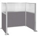A grey and white Versare Hush Panel U-shaped cubicle with glass panels.