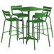 A Lancaster Table & Seating green bar height outdoor table with four chairs and an umbrella.