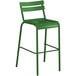 A green bar stool with a white back and metal frame.