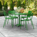A Lancaster Table & Seating green table and chairs on an outdoor patio.