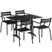 A black Lancaster Table & Seating outdoor table with four arm chairs.