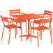 An orange powder-coated aluminum table with four chairs on an outdoor patio.