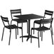 A black rectangular Lancaster Table & Seating outdoor table with chairs around it.