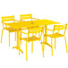 A Lancaster Table & Seating yellow aluminum table and chairs set on an outdoor patio.
