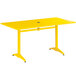 A Lancaster Table & Seating yellow aluminum table with an umbrella hole and 4 arm chairs.