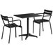 A Lancaster Table & Seating black outdoor table with umbrella hole and 2 arm chairs.