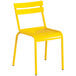 A yellow powder-coated aluminum table with an umbrella hole and 2 chairs with a white background.