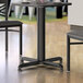 A Lancaster Table & Seating black stamped steel column table base.