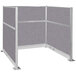 A Versare Hush Panel U-Shape cubicle with a grey fabric panel.