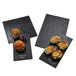 American Metalcraft black faux slate melamine platters with sandwiches and fries on a table.