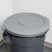 A grey Continental trash can lid on a grey trash can.
