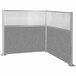 A Versare Hush Panel grey and white L-shape cubicle with glass panels.