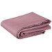 A folded pink Intedge square table cover.